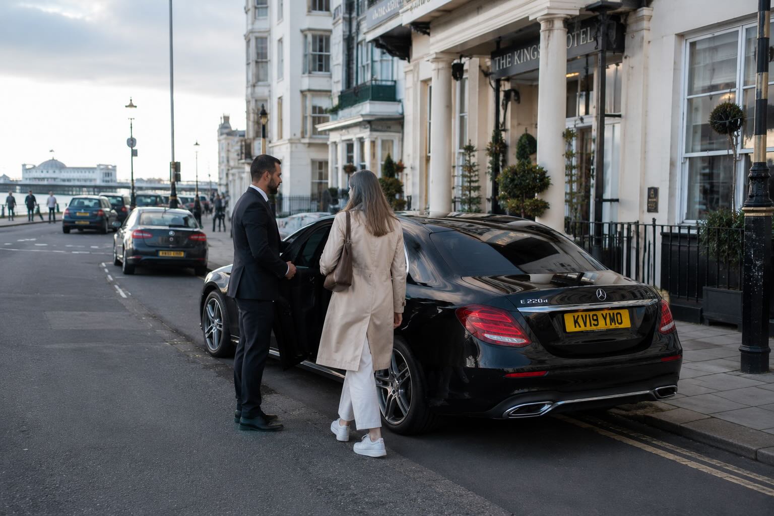 Pre-booked Brighton hotel taxi pickup with driver and passenger